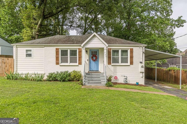 bungalow-style house with a front yard and a carport