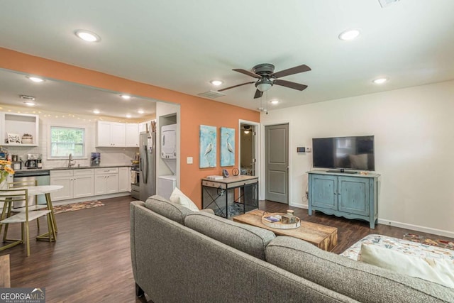 living room with ceiling fan, dark wood-type flooring, and sink