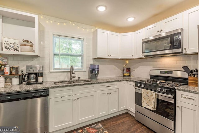 kitchen featuring white cabinetry, light stone counters, sink, and stainless steel appliances