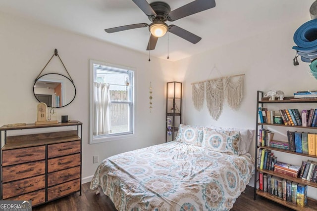 bedroom featuring ceiling fan and dark hardwood / wood-style floors