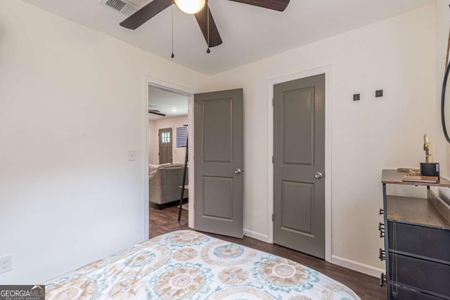 bedroom with dark hardwood / wood-style floors and ceiling fan