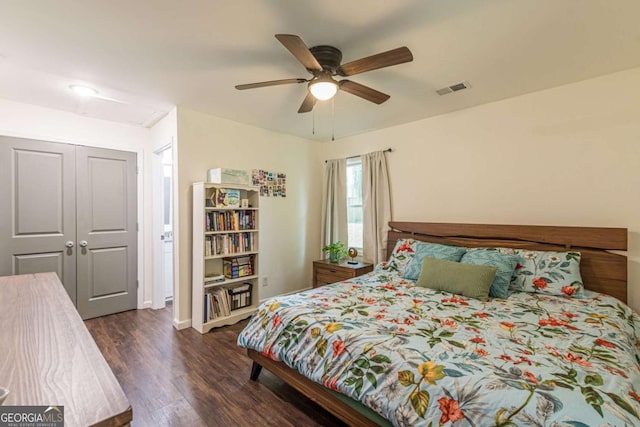 bedroom featuring ceiling fan, a closet, and dark hardwood / wood-style floors