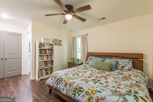 bedroom with ceiling fan and dark wood-type flooring