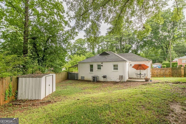 rear view of property featuring central AC, a shed, a patio area, and a lawn