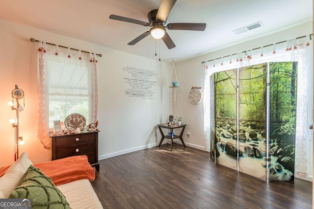 sitting room featuring dark hardwood / wood-style floors and ceiling fan