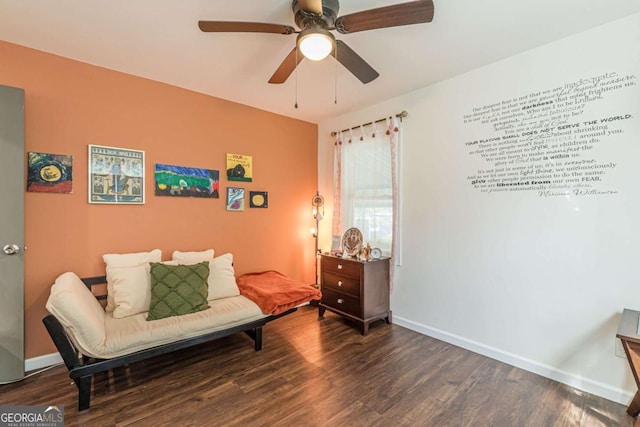 sitting room with ceiling fan and dark hardwood / wood-style flooring