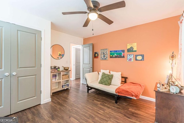 living area with dark hardwood / wood-style floors and ceiling fan