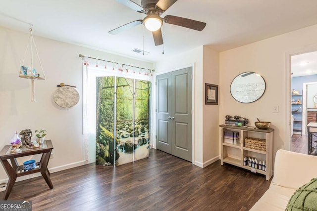 sitting room with dark hardwood / wood-style flooring and ceiling fan