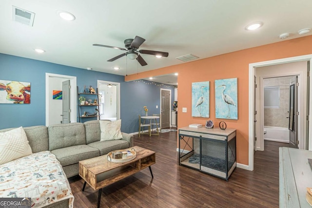 living room featuring ceiling fan and dark wood-type flooring