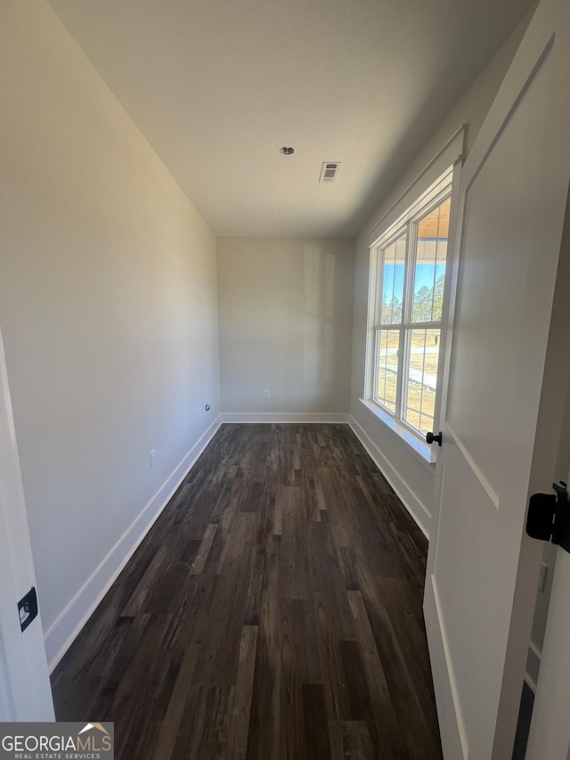 empty room featuring dark hardwood / wood-style flooring