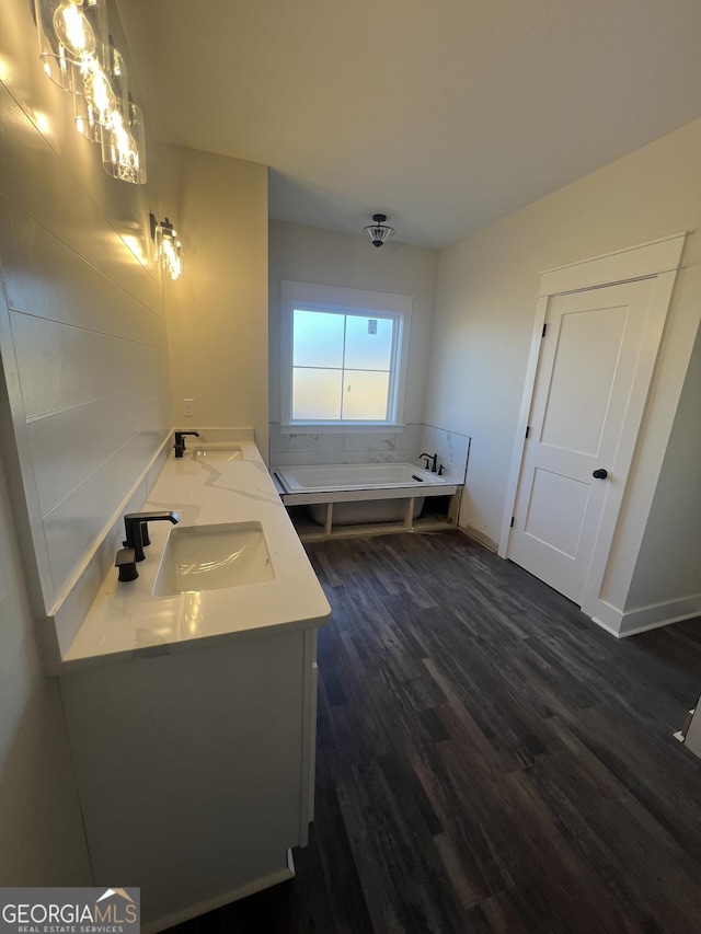 bathroom featuring vanity, hardwood / wood-style flooring, and a bathing tub