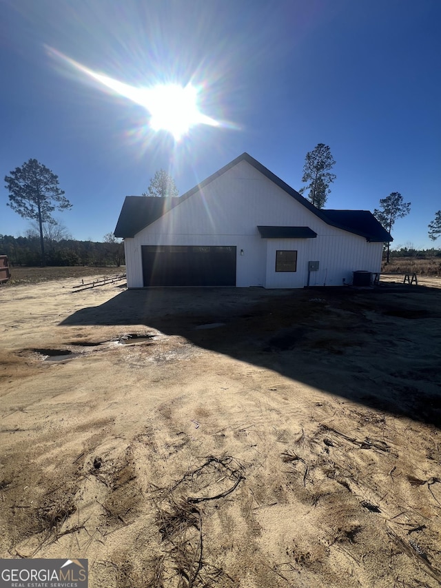 exterior space with a rural view and a garage