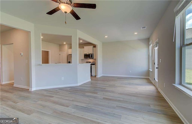 unfurnished living room with ceiling fan and light hardwood / wood-style floors