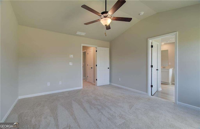 unfurnished bedroom with ceiling fan, sink, lofted ceiling, and light carpet