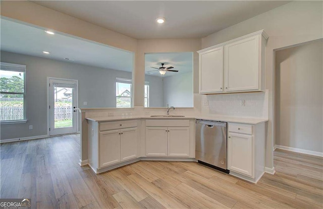 kitchen with dishwasher, sink, ceiling fan, tasteful backsplash, and white cabinetry