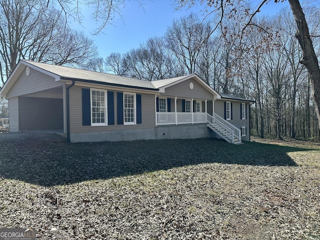 view of front of property with a carport and a porch