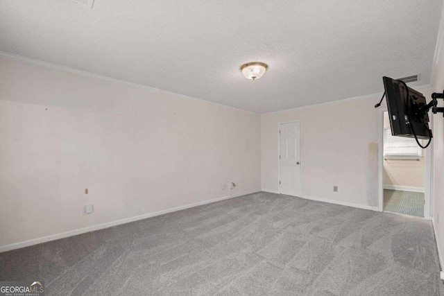 carpeted spare room featuring a textured ceiling and crown molding