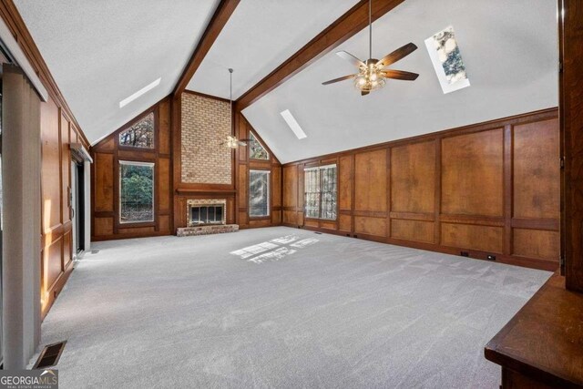 kitchen with stainless steel appliances, cream cabinets, decorative light fixtures, and light stone countertops