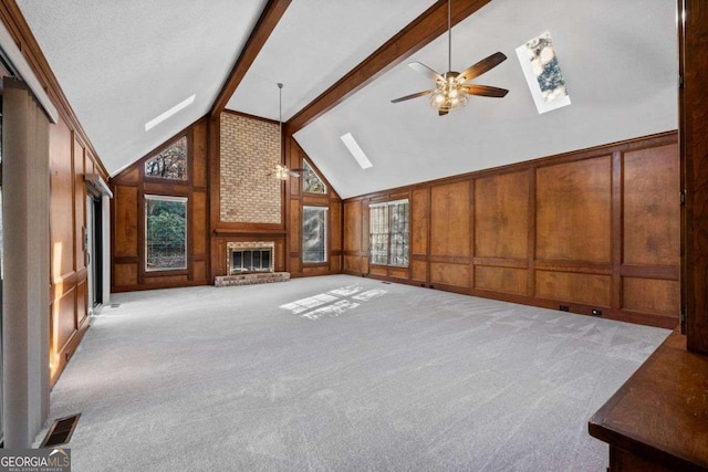 unfurnished living room featuring a skylight, ceiling fan, and visible vents