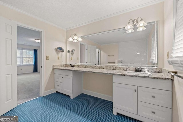 bathroom featuring a textured ceiling, ornamental molding, and vanity