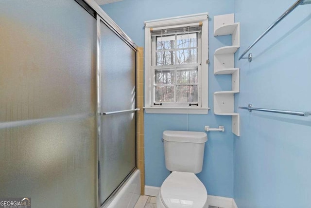 bathroom featuring toilet and enclosed tub / shower combo