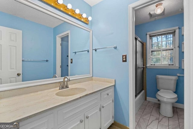 full bathroom featuring shower / bath combination with glass door, a textured ceiling, toilet, and vanity