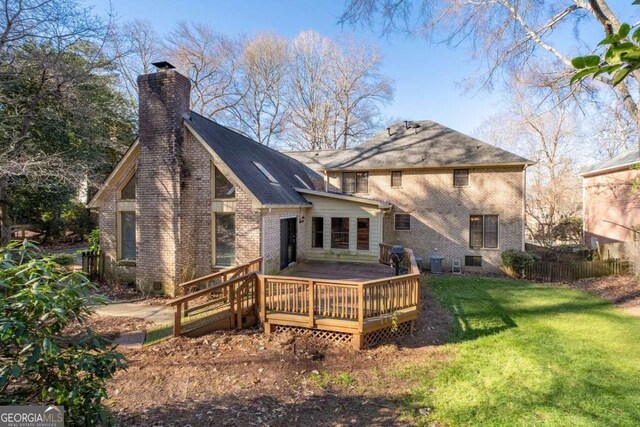 back of property with cooling unit, a yard, and a wooden deck