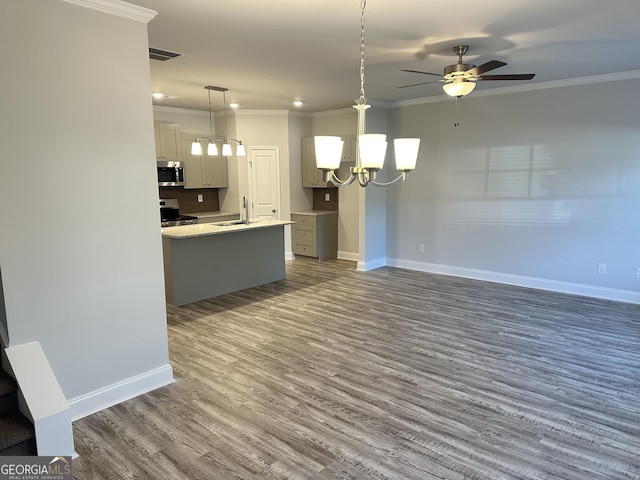 kitchen featuring decorative light fixtures, ornamental molding, and appliances with stainless steel finishes