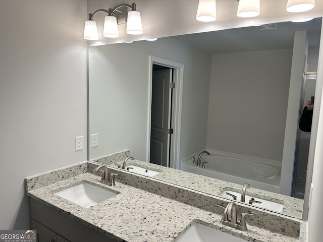 bathroom featuring vanity and a tub to relax in