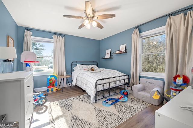 bedroom featuring ceiling fan and dark wood-type flooring