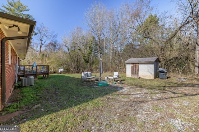 view of yard with a storage unit, cooling unit, and a deck