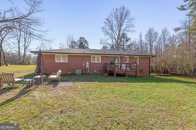 rear view of house with a yard, cooling unit, and a deck