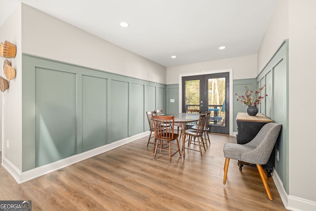 dining room with french doors and light hardwood / wood-style floors