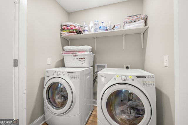 washroom with wood-type flooring and separate washer and dryer