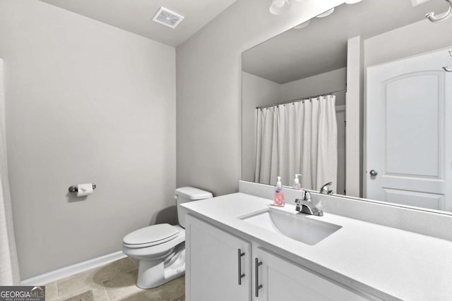 bathroom with tile patterned flooring, vanity, and toilet