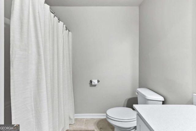 bathroom featuring tile patterned flooring, vanity, and toilet