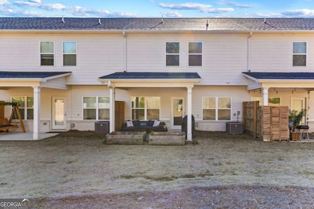 rear view of property featuring central AC unit