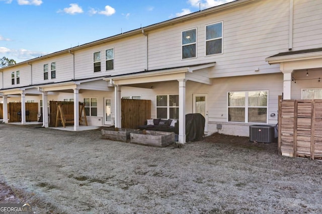 rear view of house with a patio area and central air condition unit