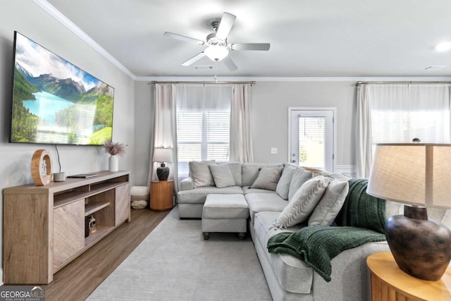 living room with crown molding, ceiling fan, and hardwood / wood-style flooring