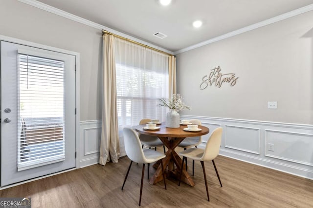 dining room featuring hardwood / wood-style flooring and ornamental molding