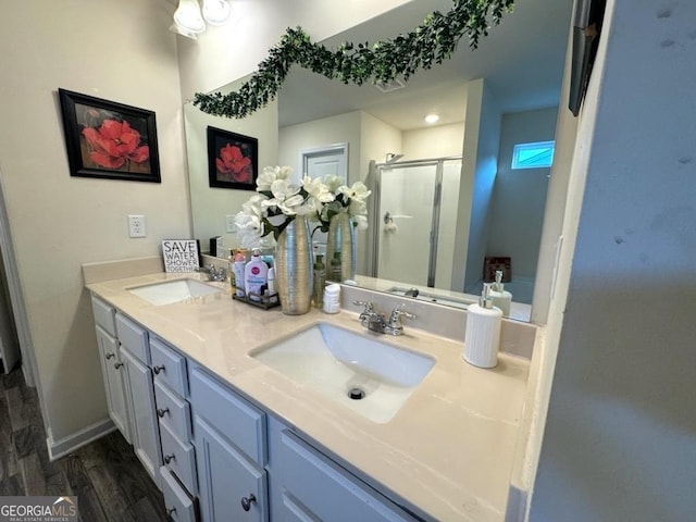 bathroom with vanity, hardwood / wood-style flooring, and walk in shower