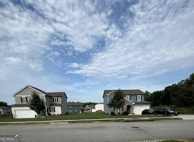 view of front of home with a front lawn and a garage