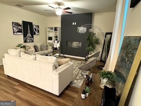 living room featuring ceiling fan and wood-type flooring