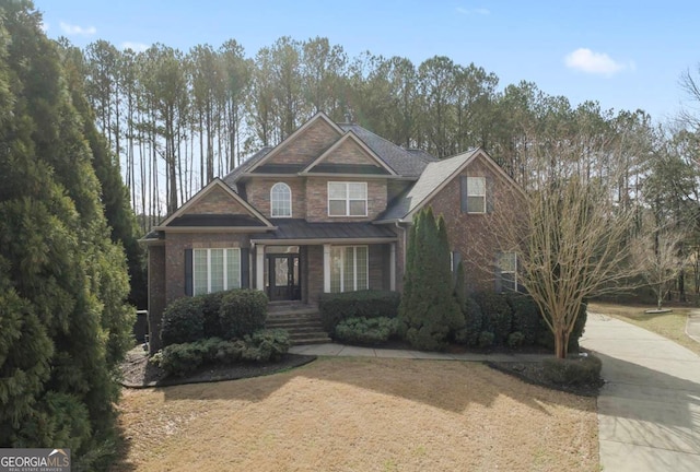 craftsman-style home featuring brick siding