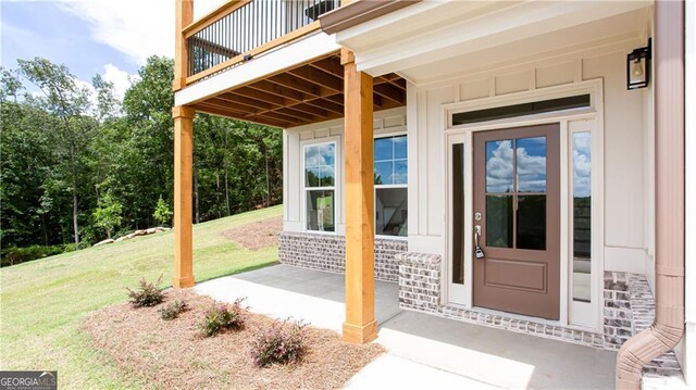 doorway to property featuring a yard