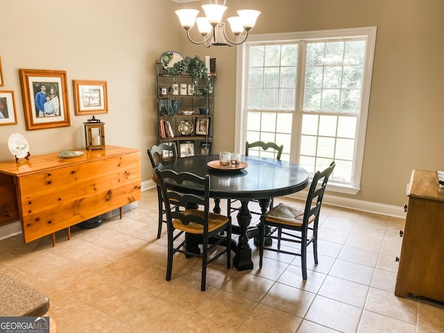 dining area featuring a healthy amount of sunlight, light tile patterned floors, and an inviting chandelier