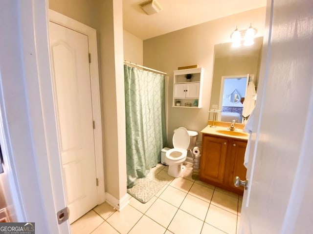 bathroom with tile patterned floors, vanity, and toilet