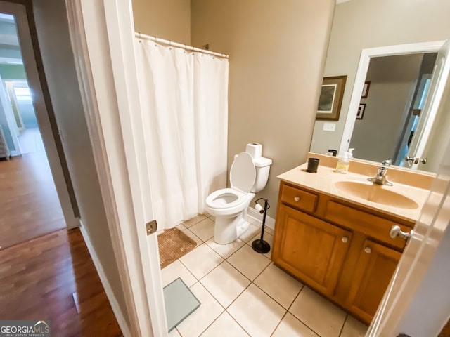 bathroom featuring tile patterned flooring, vanity, and toilet