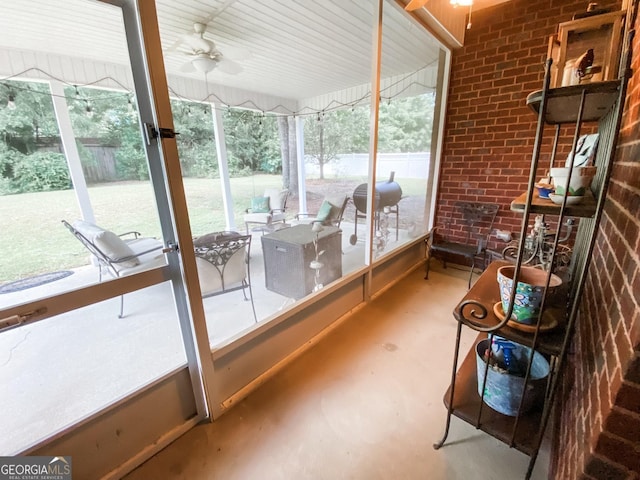 sunroom / solarium with ceiling fan and a healthy amount of sunlight