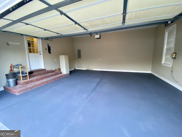 garage featuring electric panel and a garage door opener